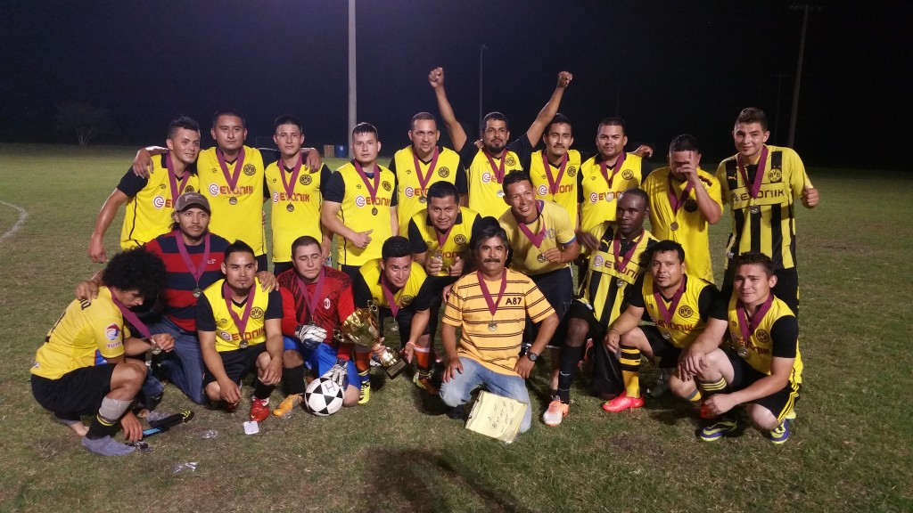 Club Hispanos pose with the Stampede cup with their coach, Bigote.